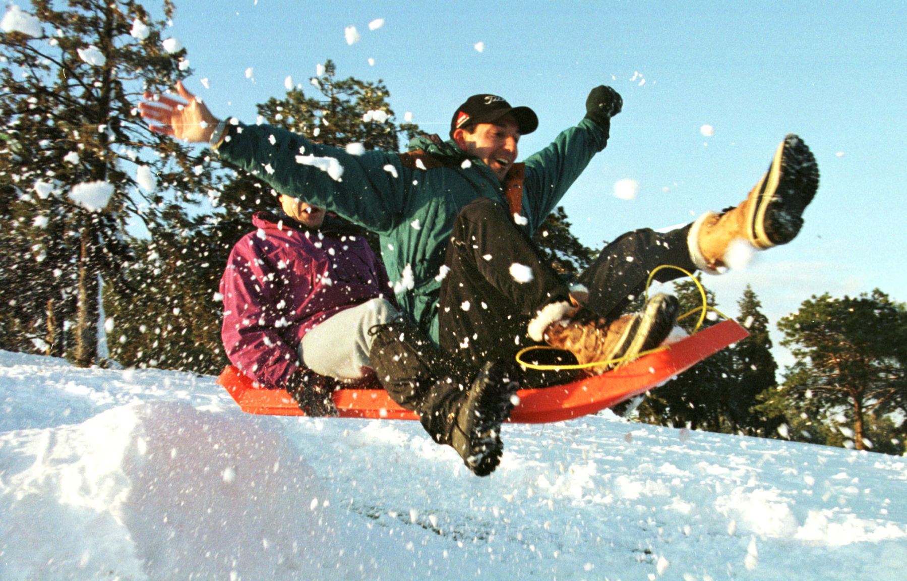 Creighton University dental students Ken Bevan (front) and Justin Coon frolic in snow at Memorial Park.